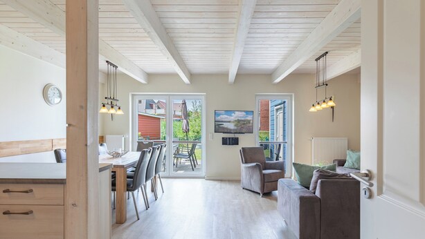 A spacious living area with a kitchen, dining area, and a view of the outdoors. - Vacation home "Fischerhuus" in Dagebüll for up to 7 people (Dagebüll)