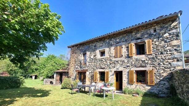 A stone building with multiple windows and doors, a grassy yard, and a tree. - Former Farm in the Loire Gorges—classified as a 3-star vacation rental (Vorey)