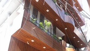 A multi-story building with a sign reading "HOTEL RADHAKRISHNA". - Hotel Drip Inn by RK (Rishikesh)