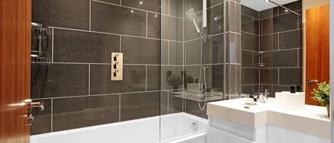 A modern bathroom with a glass-enclosed shower, a white bathtub, and a vanity with a mirror.