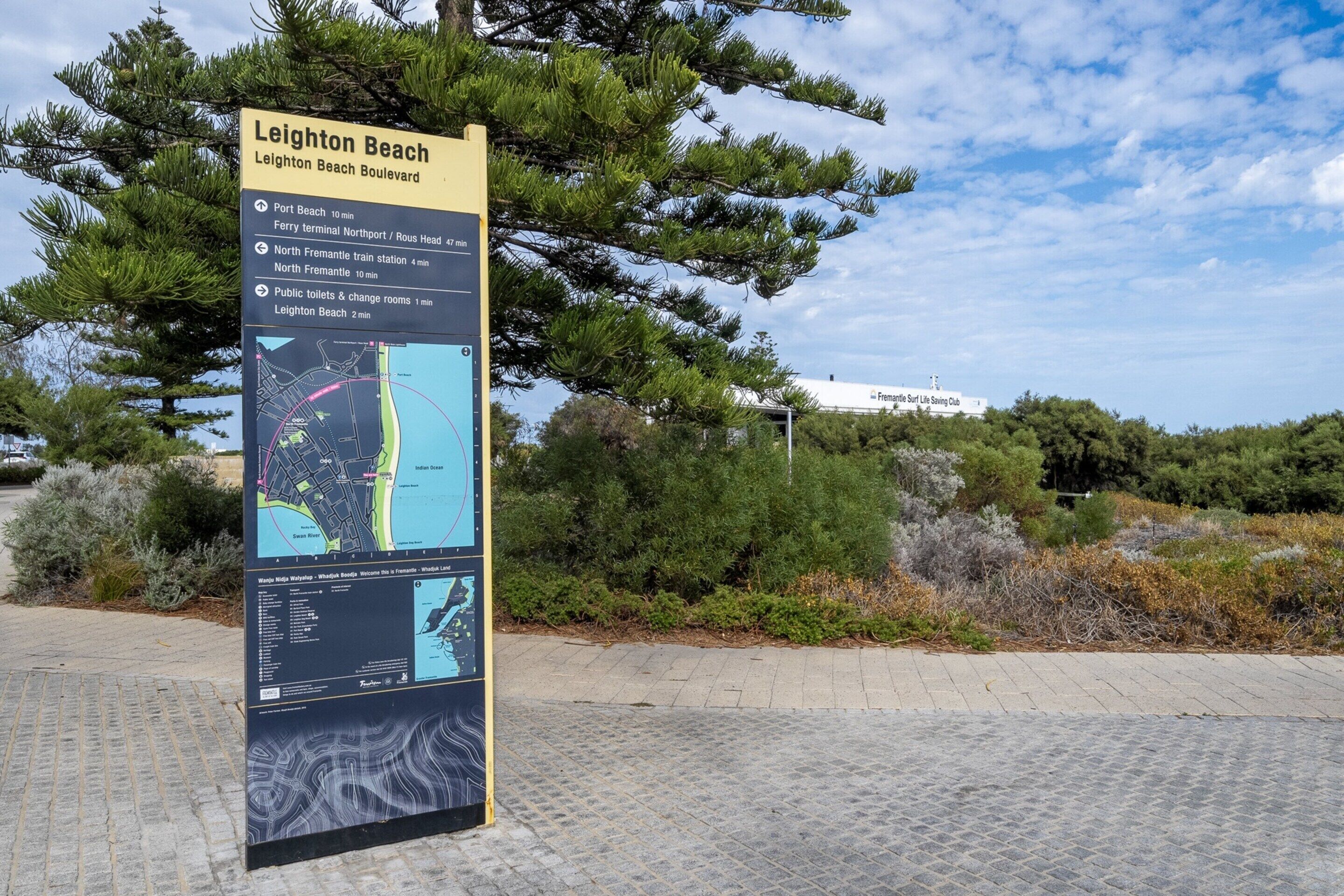 A directional sign at Leighton Beach Boulevard with a map and travel times to nearby locations.