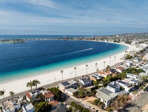 A coastal residential area with houses, a beach, and a clear view of the ocean. - Incredible Single Family Waterfront Beach Home w/ AC and Ample Parking (San Diego)