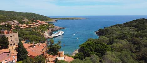 Un poble costaner amb arquitectura tradicional, un port esportiu i embarcacions a l'aigua.