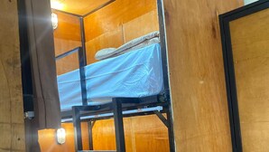 A bunk bed room with wooden walls and a ladder. - Fi Hostel Kuta (Kuta)