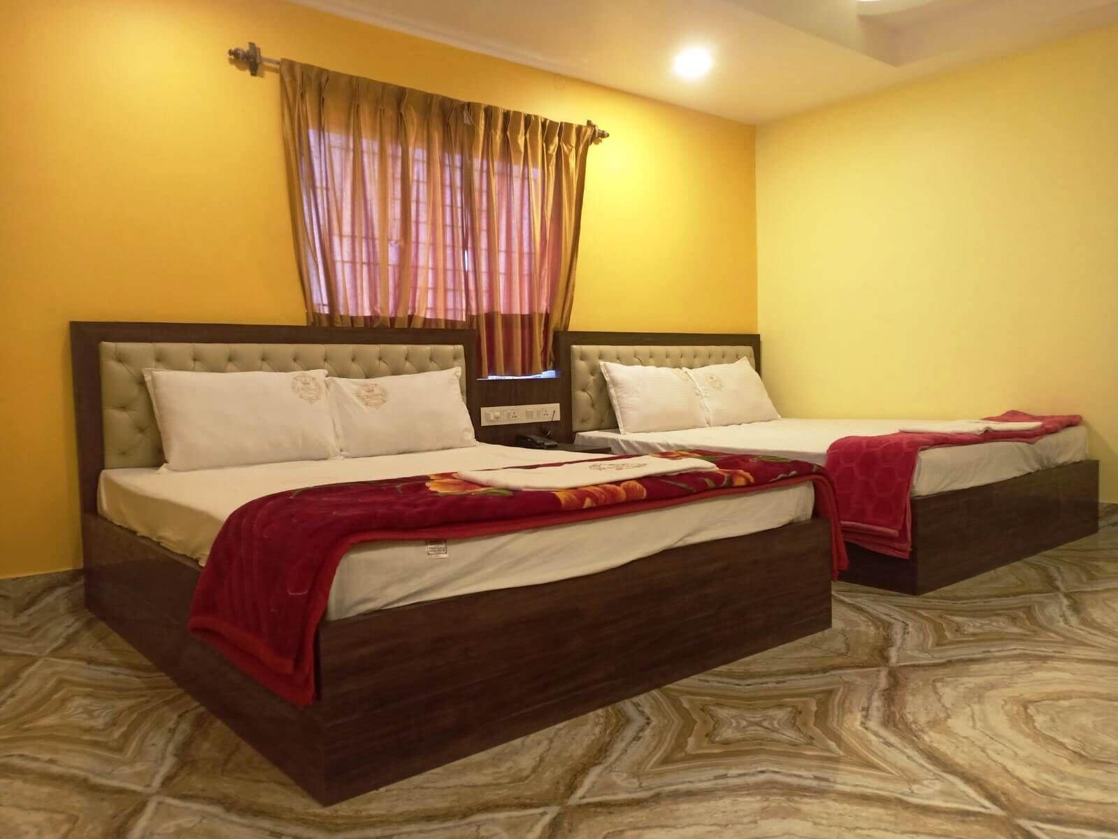 Une chambre d’hôtel avec deux lits, une grande fenêtre avec des rideaux et un sol à motifs de marbre.