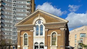 A building with a classic architectural style, featuring a central entrance with arched windows and a symmetrical facade. - Modern Studios Malvern Road  (London)