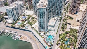 A high-rise hotel with multiple balconies, a swimming pool, and a marina. - Ocean & marina view w/ steps to Waikiki Beach (Honolulu)