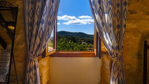 A room with a window, curtains, and a view of a landscape. - Holiday Home 'Son Pons' with Mountain Views, Wi-Fi & Air Conditioning (Llucmajor)