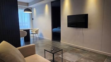 Luxury Suite | Living area | 42-inch LED TV with satellite channels