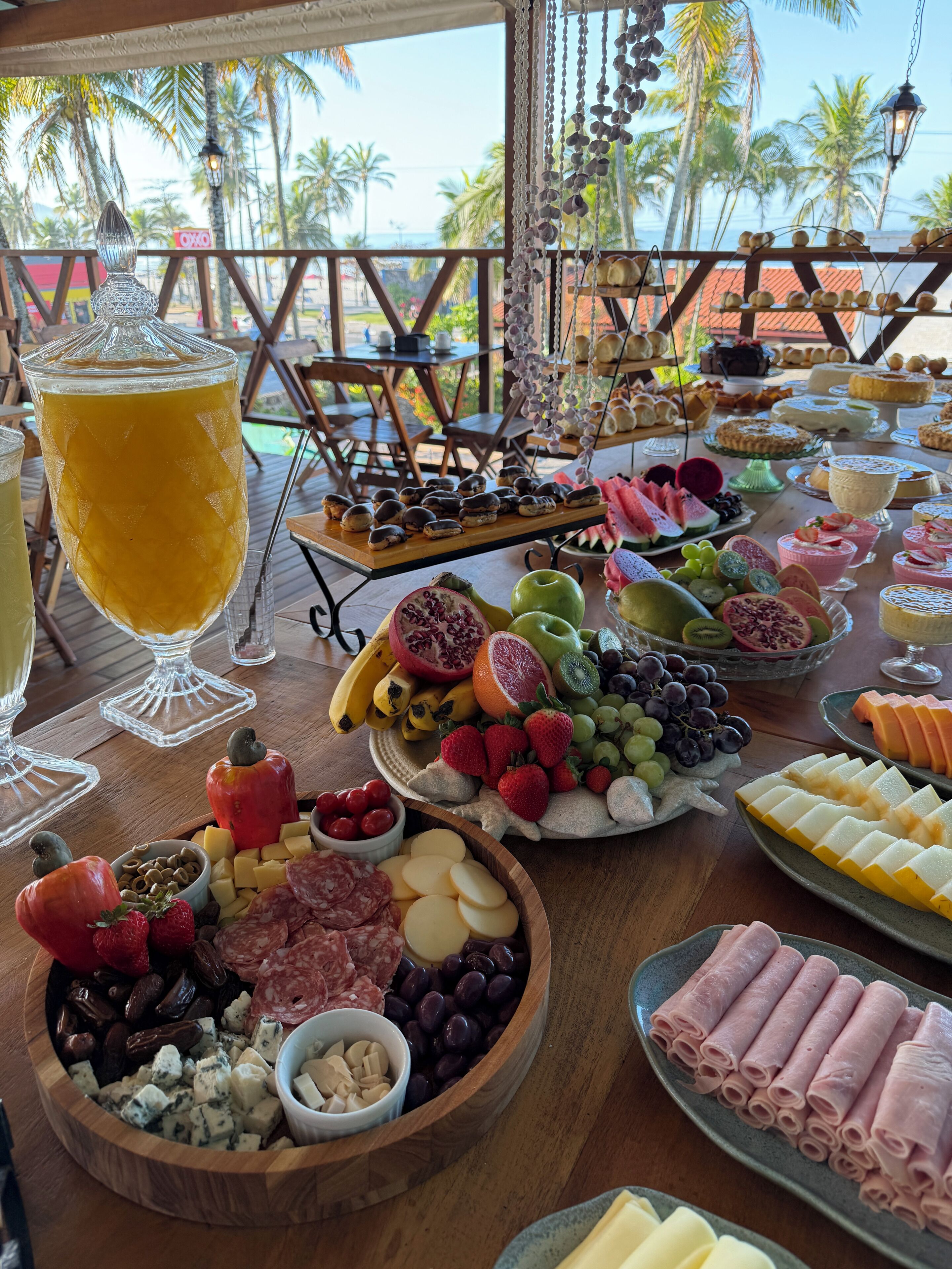 A buffet table with various food items and a large beverage.