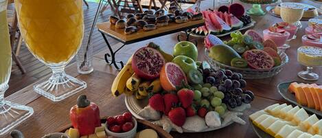 A buffet table with various food items and a large beverage.