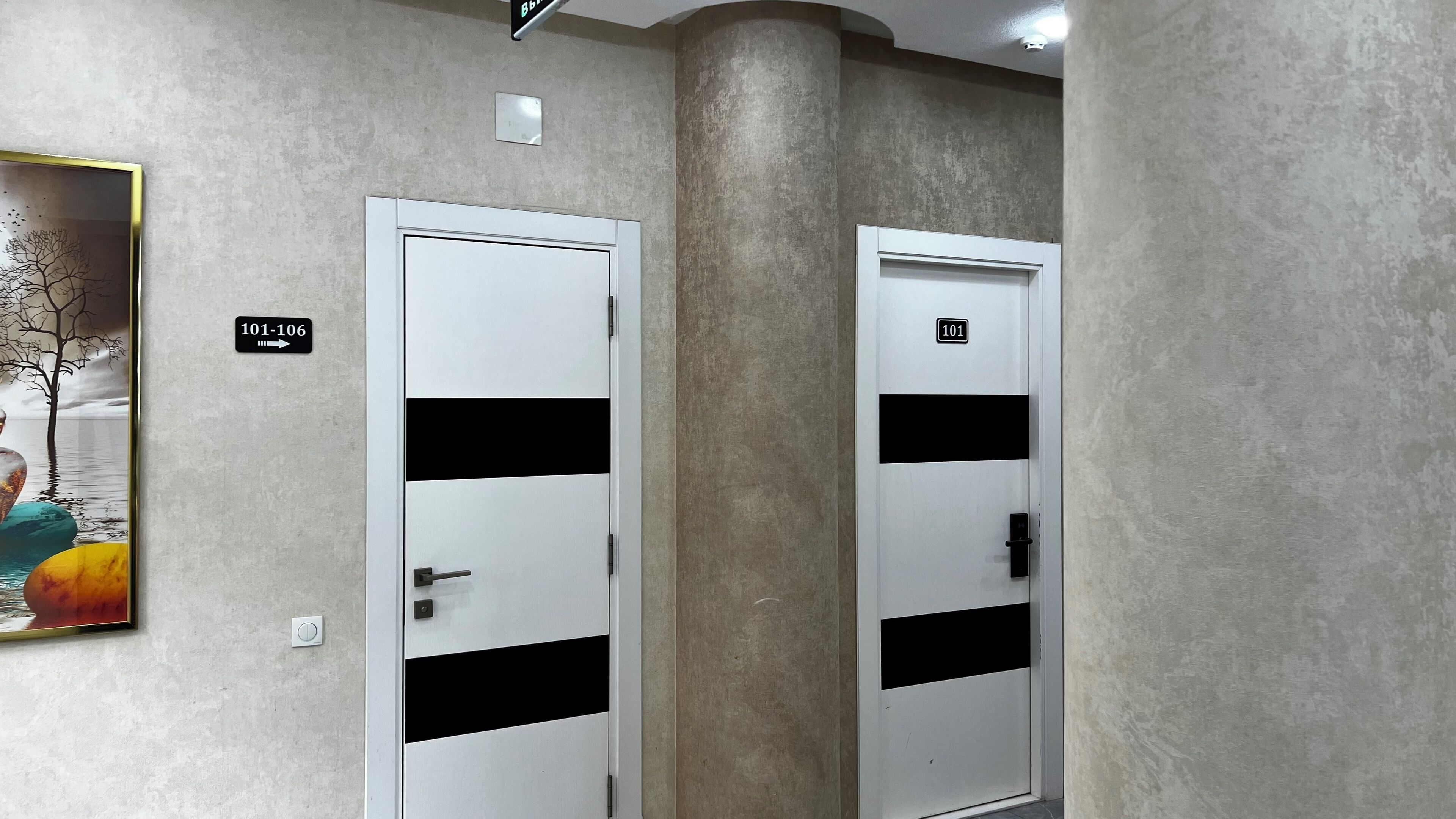 Two white doors with black horizontal stripes, each marked with a number.