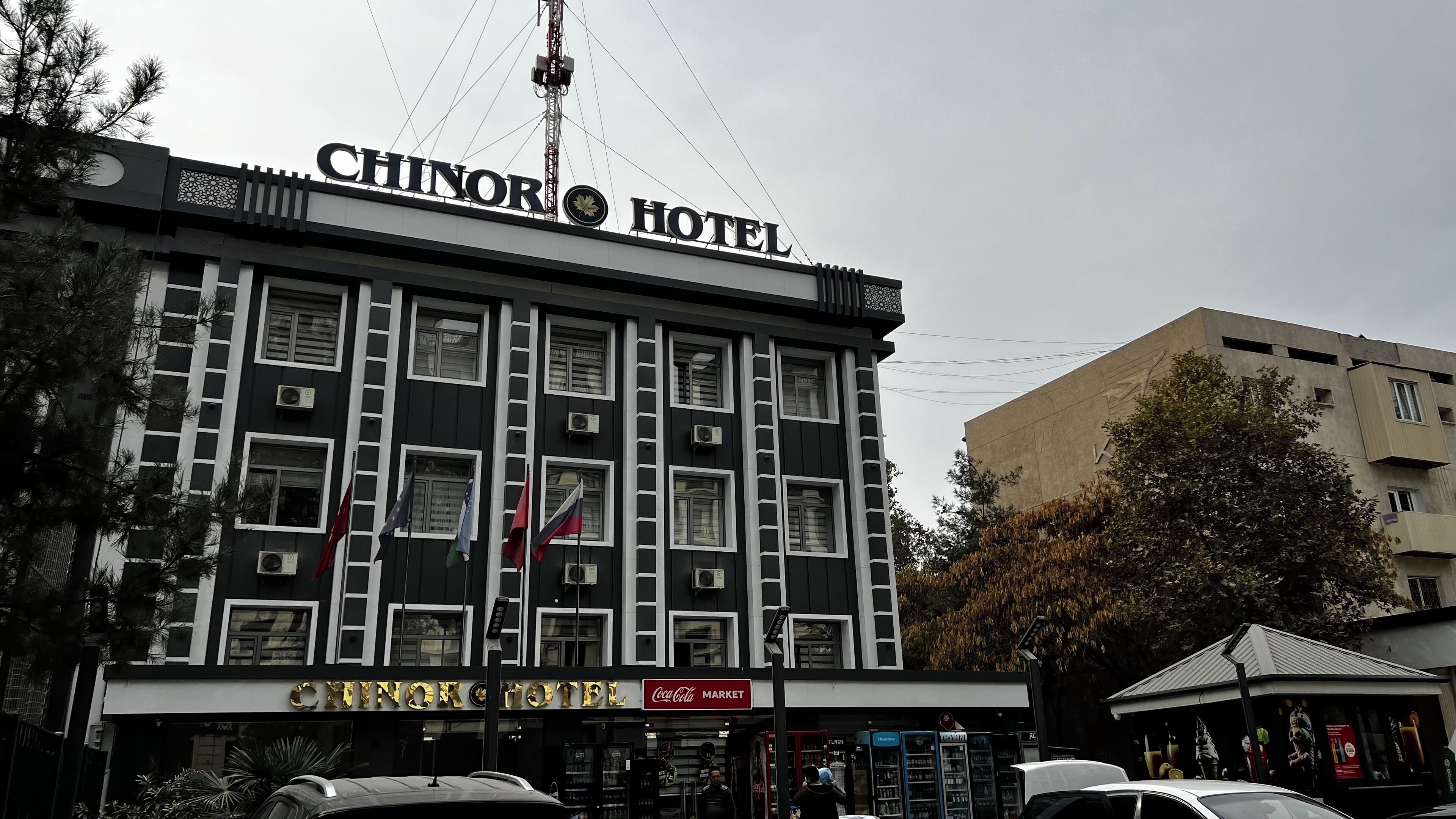 A hotel named 'CHINOR HOTEL' with a Coca-Cola market and several vending machines.