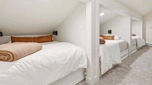 A bedroom with two beds, white bedding, and a beige blanket. - Giant Steps 30 Ski in/Ski out (Brian Head)