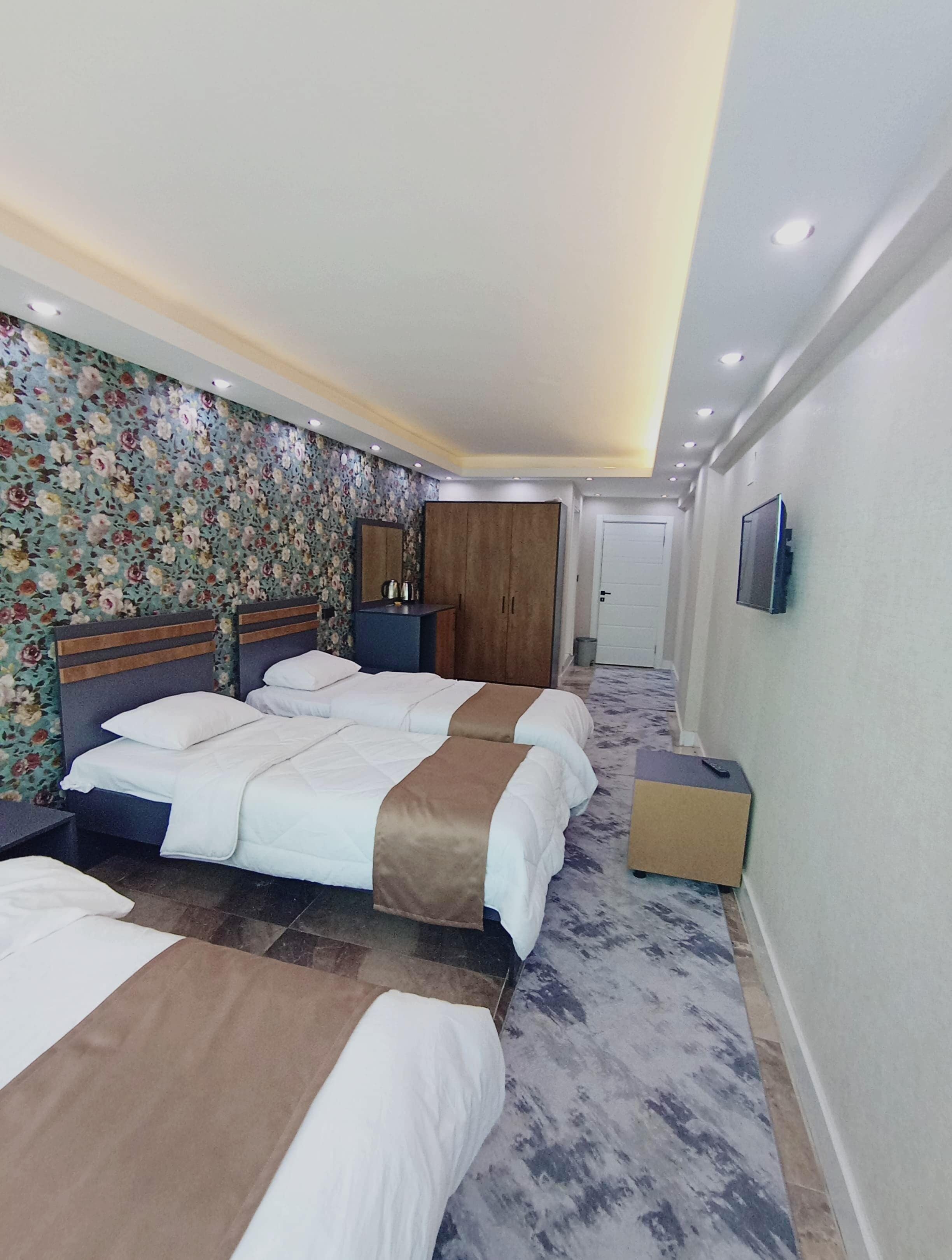 Standard Quadruple Room, City View | In-room safe, desk, laptop workspace, blackout drapes