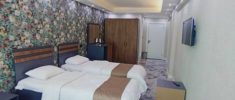 Standard Quadruple Room, City View | In-room safe, desk, laptop workspace, blackout curtains