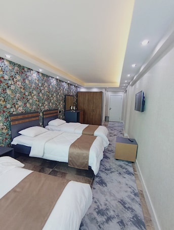 Standard Quadruple Room, City View | In-room safe, desk, laptop workspace, blackout drapes