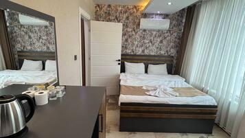 Standard Suite, City View | In-room safe, desk, laptop workspace, blackout drapes