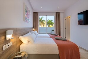 A hotel room with two beds, a TV, a painting, and a balcony with a view. - Villa Deluxe Suites Maspalomas (Maspalomas)