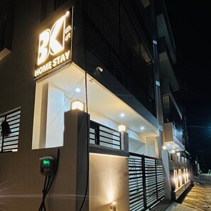 A building with a sign reading "BK HOME STAY" at night. - BK Homestay (Varanasi)