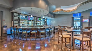 A bar area with a curved ceiling, multiple TVs, and a variety of seating options including bar stools and tables. - 1 Mi to Beach! Resort Retreat w/ Pool in Destin (Destin)