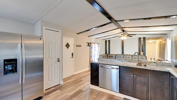 A modern kitchen with stainless steel appliances, a dishwasher, and a dark wood cabinet. - Heart of Greensboro: Pet-friendly Gem 3 Mi to Dtwn (Greensboro)