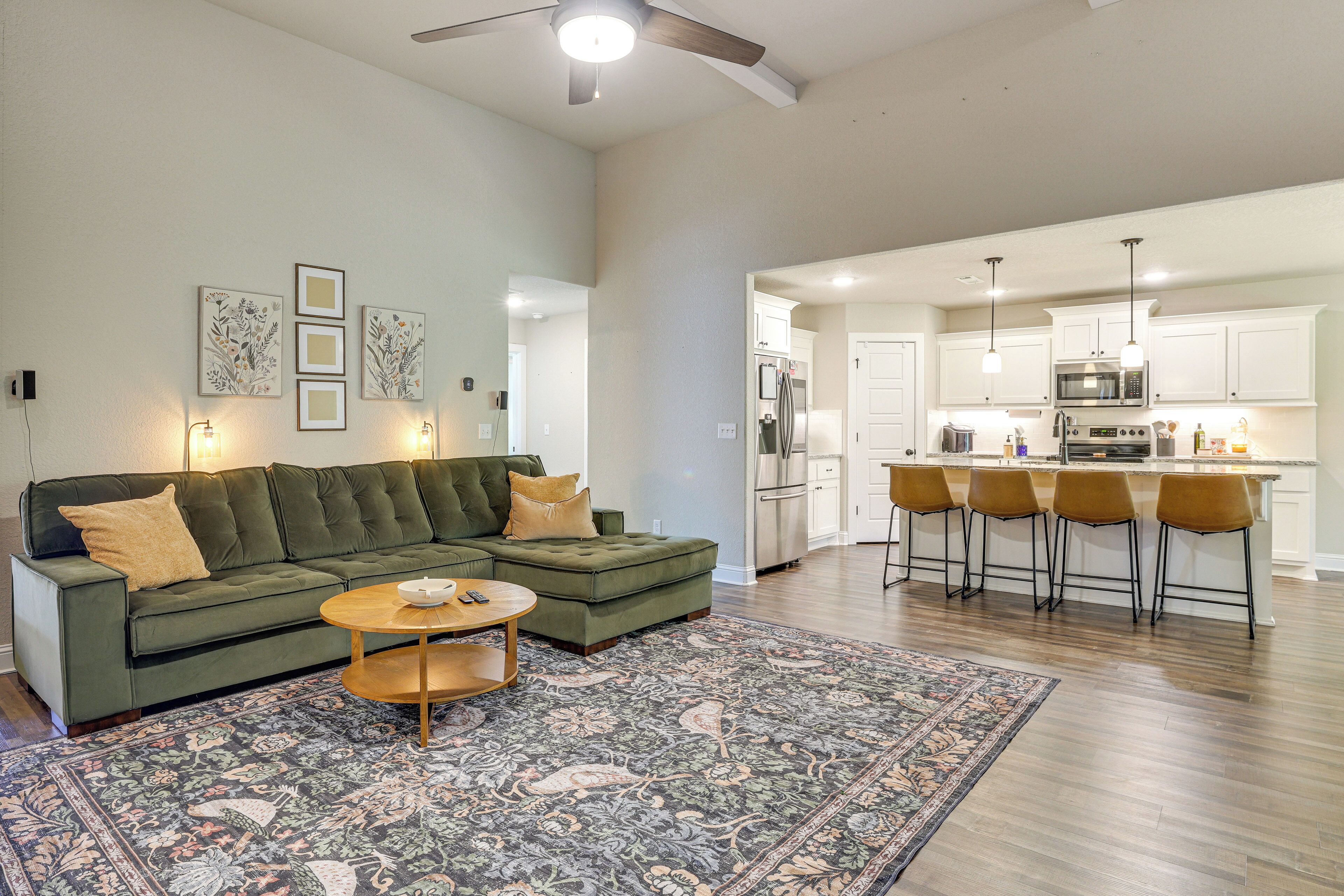 A modern living room with a sectional sofa, a coffee table, and a patterned rug.