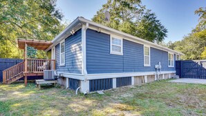 A single-story house with a covered porch, a satellite dish, and a fenced yard. - Coastal Convenience! Mt Pleasant Gem 2 Mi to Ocean (Mount Pleasant)