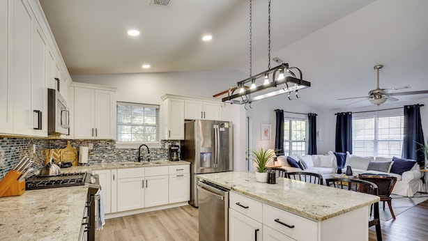 A modern kitchen with white cabinets, stainless steel appliances, and a granite countertop. - Coastal Convenience! Mt Pleasant Gem 2 Mi to Ocean (Mount Pleasant)