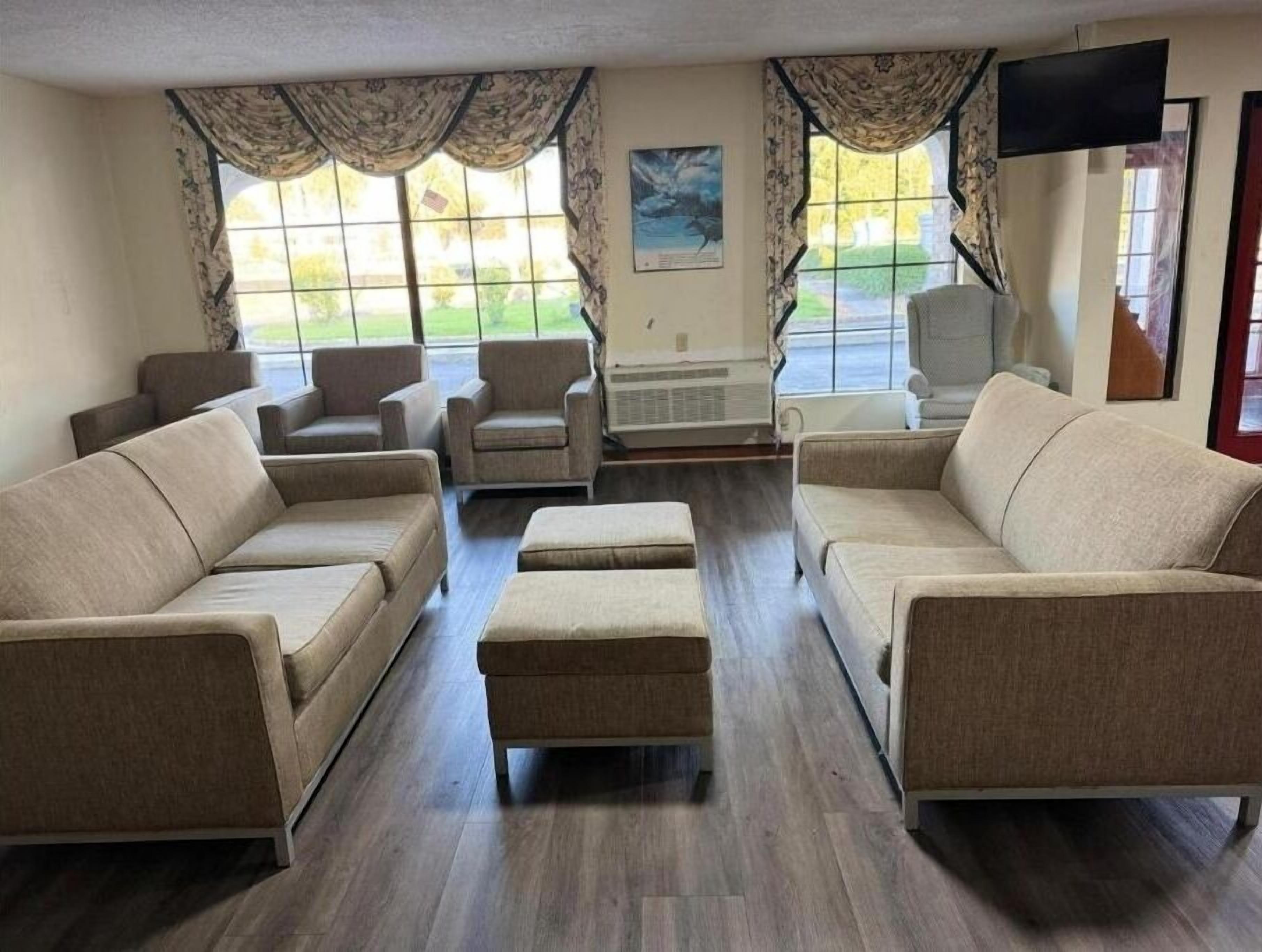 Lounge by bright windows on plush seating after your drive.
