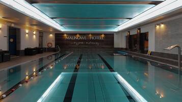 Indoor pool, open 8:00 AM to 10:00 PM, pool loungers, lifeguards on site