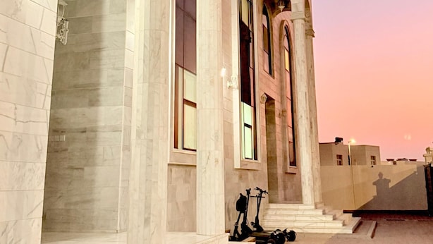 A building with large arched windows and a set of steps leading to the entrance. - Rizq Luxurious Villa (Dubai)