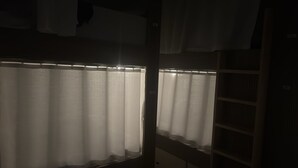 A dimly lit room with a window covered by a sheer white curtain. - Rizq Luxurious Villa (Dubai)
