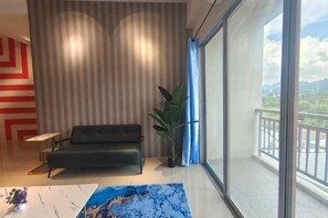 A modern living room with a sofa, a coffee table, and a large window offering a view of the outdoors. - Pavilionvillie M1T584 by Irainbow (Kinta)