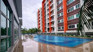 A swimming pool area with a building in the background. - Pavilionvillie M1T584 by Irainbow (Kinta)