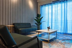 A living room with a sofa, a coffee table, and a potted plant. - Pavilionvillie M1T584 by Irainbow (Kinta)
