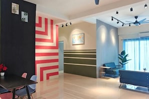 A modern hotel lobby with a reception desk, seating area, and a large window with curtains. - Pavilionvillie M1T584 by Irainbow (Kinta)