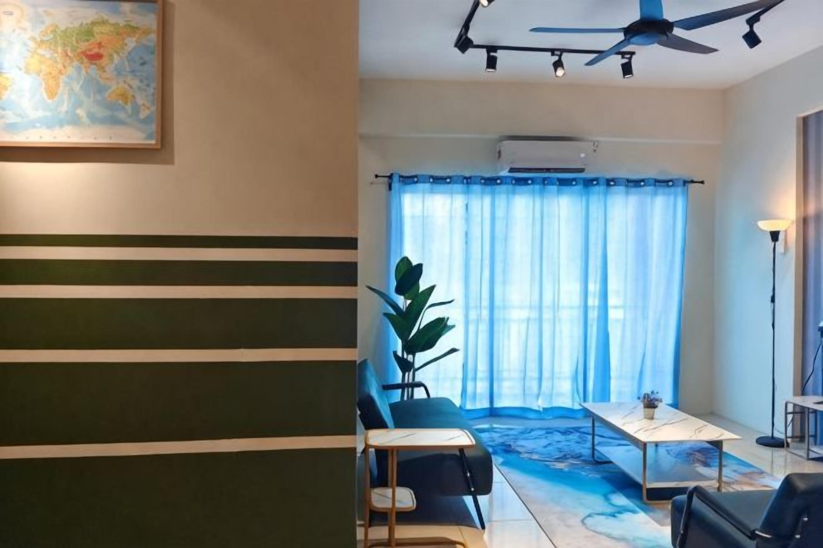 A room with a ceiling fan, a map on the wall, a dining table, and a large window with curtains.