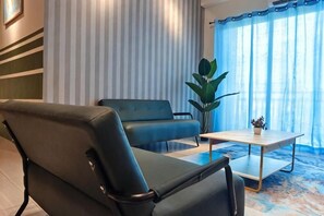 A room with a sofa, a small table with a plant, and a window with curtains. - Pavilionvillie M1T584 by Irainbow (Kinta)