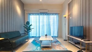 A living room with a sofa, a coffee table, a TV, and a large window with curtains. - Pavilionvillie M1T584 by Irainbow (Kinta)