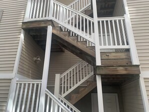 A multi-level wooden staircase with white railings leading to an upper floor. - Spacious 4 Bedroom 2 Bath First Floor unit in the South End of Wildwood (Wildwood)