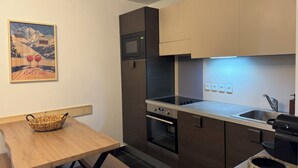 A modern kitchen with a built-in oven, microwave, and stainless steel sink. - T3 apartment 50 meters from the slopes - Heart of the resort. (Les Deux Alpes)
