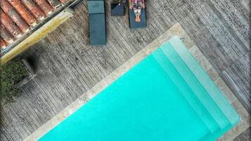 Seasonal outdoor pool, open 9:00 AM to 10:00 PM, pool umbrellas