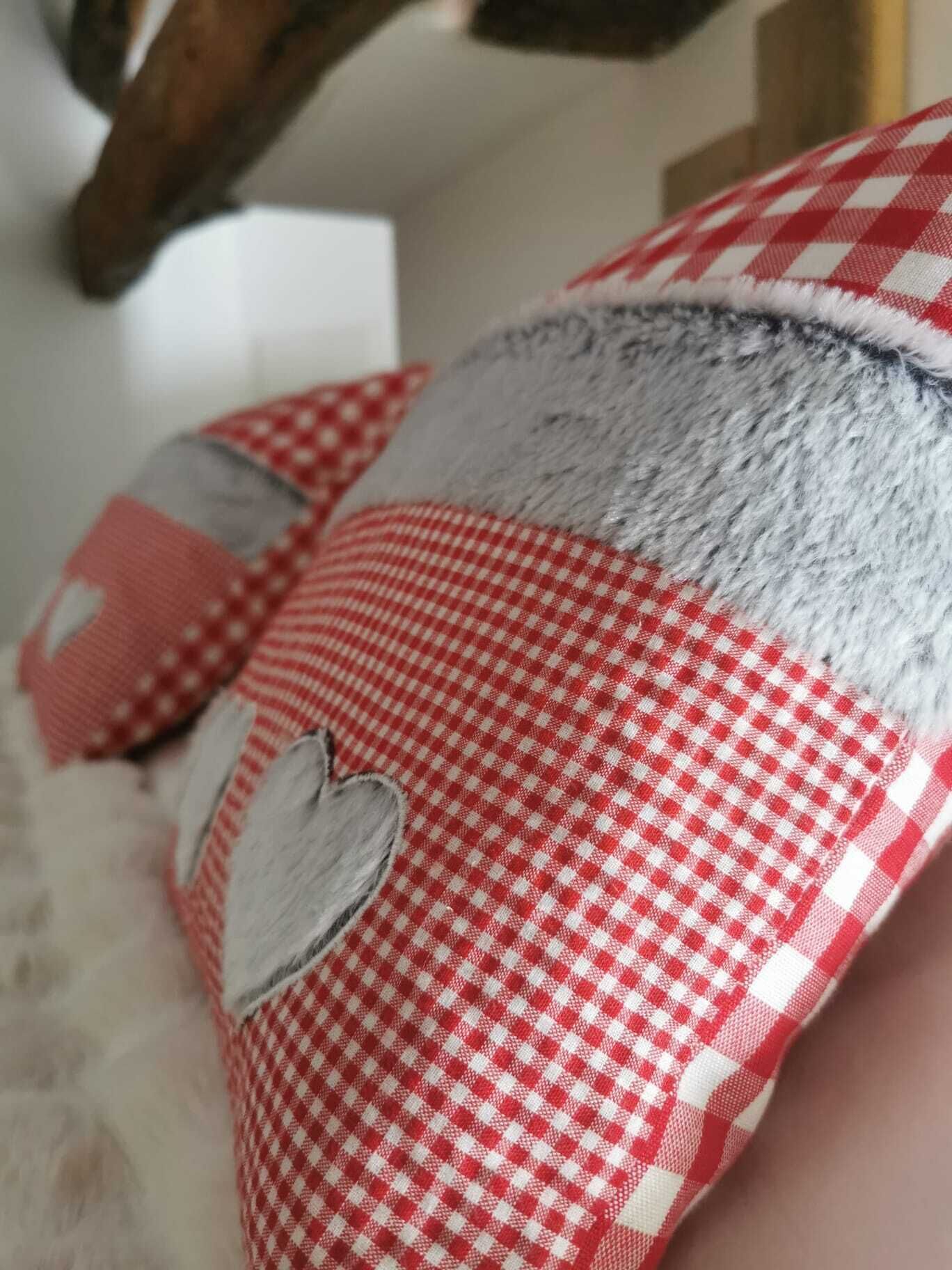 A close-up of a red and white checkered fabric with a heart-shaped cutout.