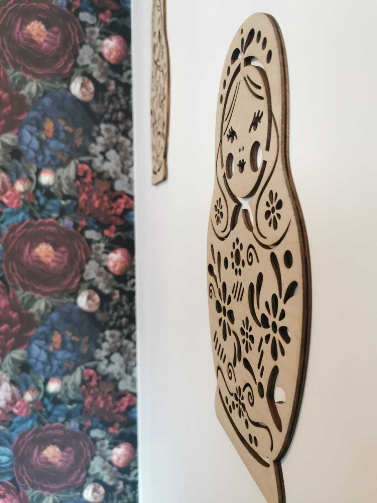 A wooden decorative piece with intricate patterns, possibly a wall hanging or a piece of furniture.