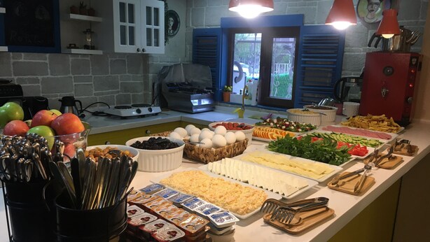 A buffet with various food items and utensils. - ROTA GEZGİN PANSİYON (Eskisehir)