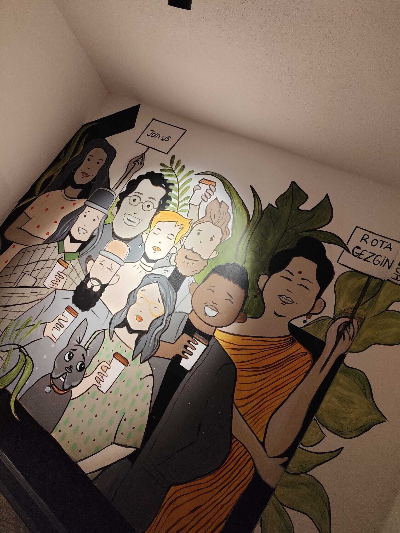 A mural with various characters and text, including "ROTA GEZGİN" and "Join us".