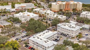 An aerial view of a coastal town with buildings, roads, and parked cars. - Canopy Couplet | 2 Upscale Apts In Prime Location (Safety Harbor)