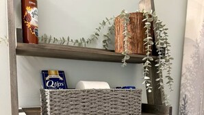 A wooden shelf with a box of Q-tips, a bottle of lotion, and a woven basket. - 2120  Hot tub, sauna & more resort amenities Beautifully remodeled, 1st-floor (Beech Mountain)
