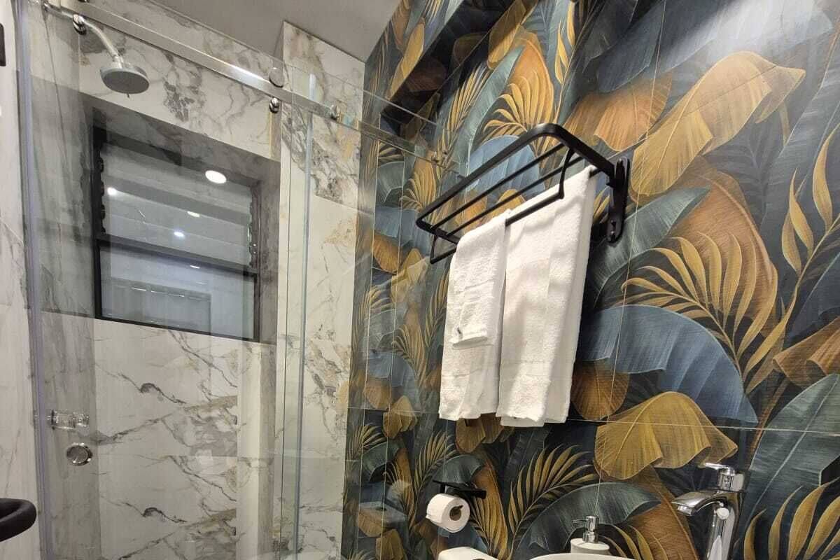 A bathroom with a shower, toilet, and sink.